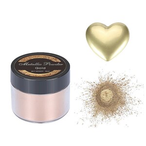 May include: A small jar of gold metallic powder with a black lid. The jar has a label that says "Metallic Powder Gold Net Weight: 20ml". There is a pile of gold powder next to the jar and a gold heart shape.