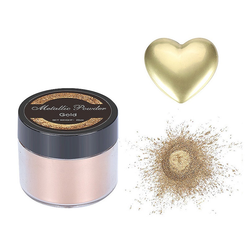May include: A small jar of gold metallic powder with a black lid. The jar has a label that says "Metallic Powder Gold Net Weight: 20ml". There is a pile of gold powder next to the jar and a gold heart shape.