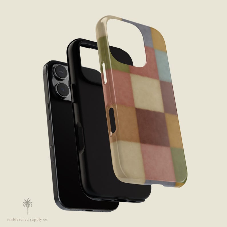 This phone case features a soft, muted checkerboard pattern made up of square blocks in earthy tones—dusty pink, cream, sage green, mustard yellow, brown, and light blue. Each square has a slightly textured, vintage look, creating a warm, cosy, quilt-like aesthetic. No additional graphics or text appear on the case the buyer receives.