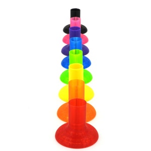 May include: A set of ten colorful plastic cones, arranged in a rainbow order from purple to red. The cones are all the same size and shape, and they are all standing upright on a white surface.