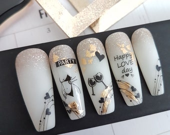 Sparkly shades of gold for Valentine's day, milky white nails with black hearts with golden accents, unique nail design,be my valentine