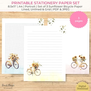 Puede incluir: Juego de papel de papelería imprimible con tres páginas: rayado, sin rayar y cuadriculado. Cada página tiene una ilustración de acuarela de una bicicleta amarilla con una cesta de girasoles. El texto de la imagen dice "PRINTABLE STATIONERY PAPER SET".