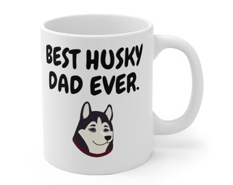 May include: White ceramic coffee mug with a black and white illustration of a husky dog and the text "Best Husky Dad Ever."