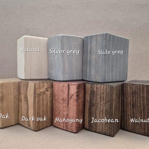 May include: A collection of wooden blocks in various colors, including natural, silver grey, and slate grey. The blocks are labeled with their respective names. Other colors include oak, dark oak, mahogany, Jacobean, and walnut.