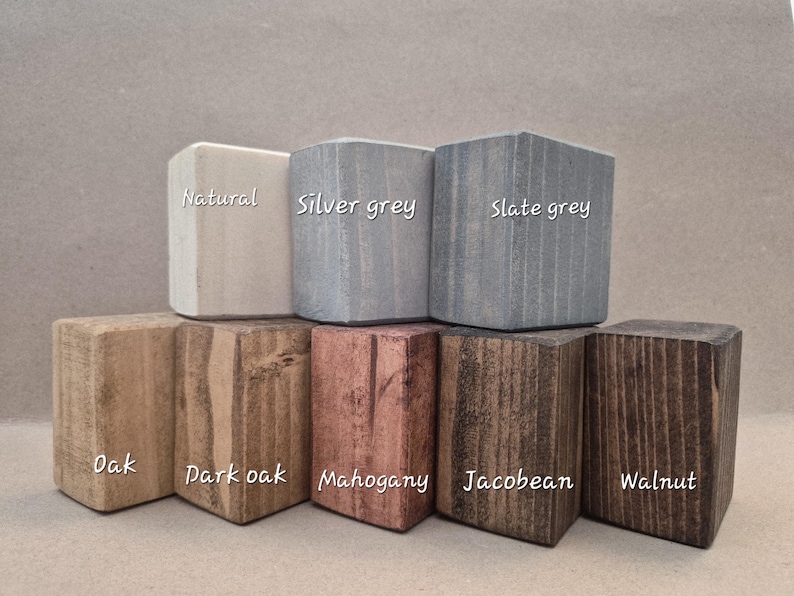 May include: A collection of wooden blocks in various colors, including natural, silver grey, and slate grey. The blocks are labeled with their respective names. Other colors include oak, dark oak, mahogany, Jacobean, and walnut.