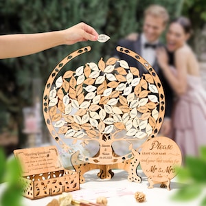 May include: Wooden wedding guest book alternative shaped like a tree, with leaf-shaped tags for guests to sign. Includes a matching box and a sign that says "Please leave your name and your best wishes for Mr & Mrs".