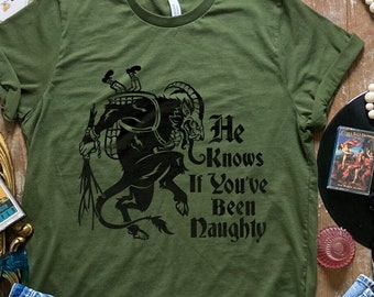 Krampus T-Shirt – "He Knows If You've Been Naughty" | Gothic Christmas Shirt | Unisex Sizes | Spooky Holiday Apparel