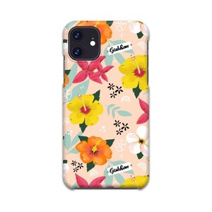 May include: A pink phone case with a floral pattern featuring yellow, orange, red, and white hibiscus flowers. The text "Gu&aring;han" is printed on the case.