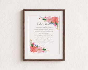 May include: A framed print featuring the text "I Padre Nuestro" in black script, followed by the Lord's Prayer in Chamorro. The text is surrounded by watercolor illustrations of pink and coral hibiscus flowers, green leaves, and small blue accents.