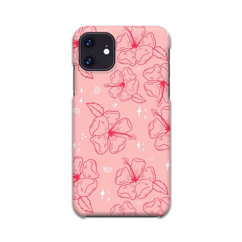 May include: A pink phone case with a floral pattern. The flowers are red and white and have a delicate, hand-drawn style. The background is a light pink color.