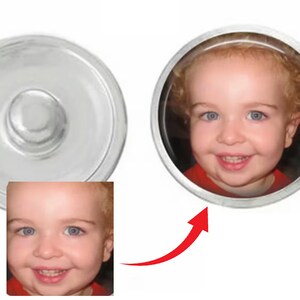 May include: A silver snap button with a clear, raised center. A circular button features a smiling child with blue eyes and curly blonde hair. The child is wearing a red shirt. An arrow points from the child's image to the button.