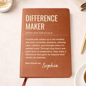 May include: A brown leather-bound journal with the words "DIFFERENCE MAKER" in large white letters. The journal includes a definition and a dedication to nurses, with the name "Sophia" at the bottom. A red ribbon bookmark is visible.