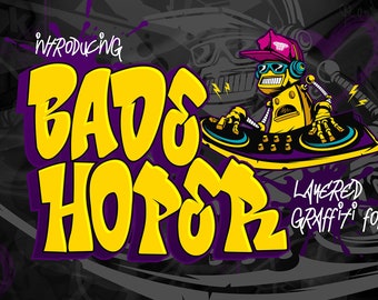 May include: A yellow and purple layered graffiti font design with the text "Introducing BADE HOPPER LAYERED GRAFFITI FONT". A cartoon robot wearing a backwards hat and sunglasses is mixing music on a turntable.