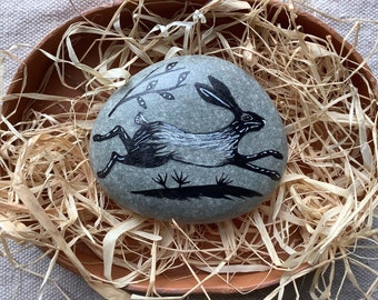 Running Hare . Painted stone.