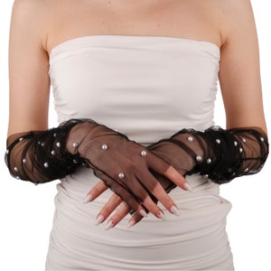 May include: A pair of black sheer gloves with pearl embellishments. The gloves are long and extend past the elbows.