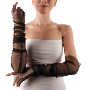 May include: A pair of long black sheer gloves with ruched detailing. The gloves extend to the elbow.