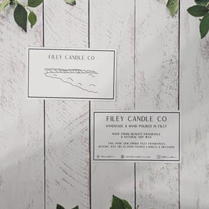 May include: Two white cards with black text and a simple line drawing of a coastline. The top card reads "Filey Candle Co." The bottom card reads "Filey Candle Co. Handmade & Hand Poured in Filey. Made from Quality Fragrance & Natural Soy Wax. Take home our unique Filey fragrances. Explore our hand poured candles & diffusers. www.fileycandles.co.uk @fileycandles"