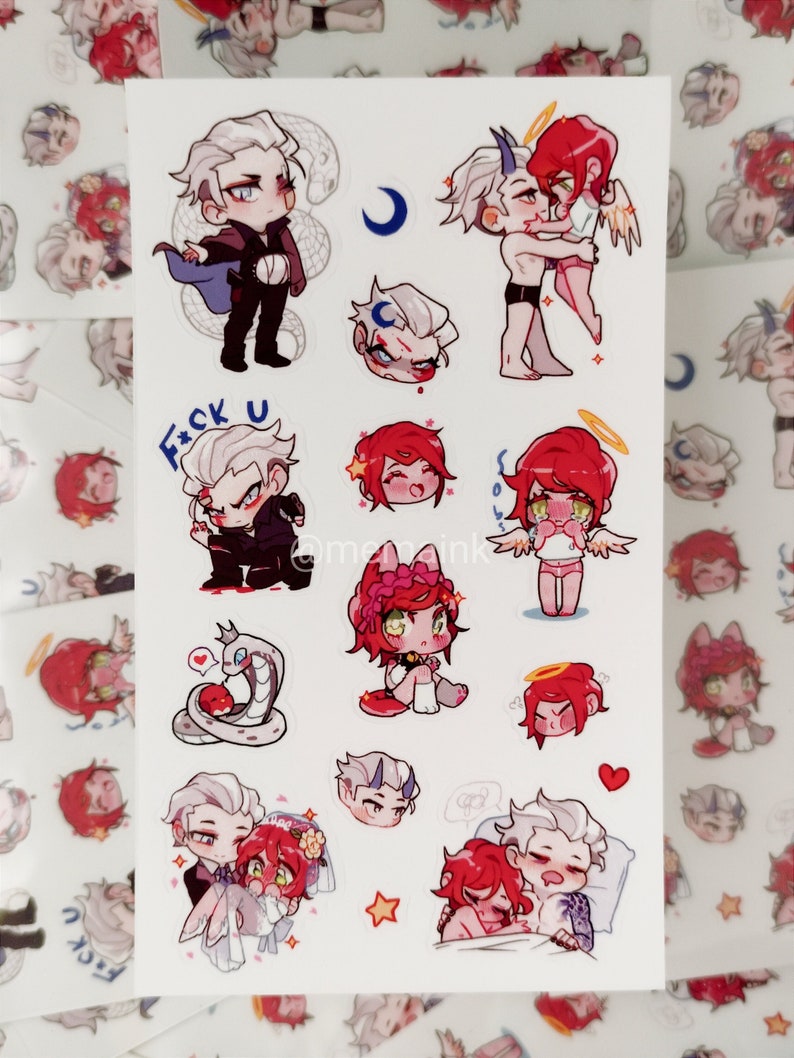 May include: A sheet of stickers with chibi illustrations. The stickers show characters with white and red hair, some with angel wings or devil horns. The designs include a snake, a crescent moon, and the text "F*ck U".