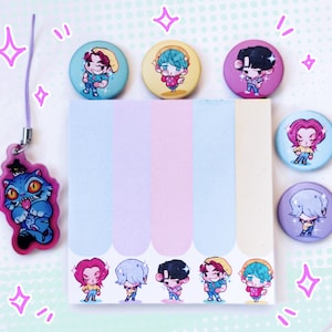 May include: A collection of colorful stationery and accessories. Includes a blue cat charm, six character button pins, and a pastel-colored sticky note pad. The pins and pad feature cartoon illustrations of characters in various outfits.