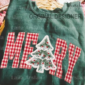 May include: A dark green sweatshirt featuring the word MERRY appliqued in a red and white gingham check pattern. The letter E is replaced by a white lace Christmas tree graphic with green embroidered pine needles and small red berry accents.