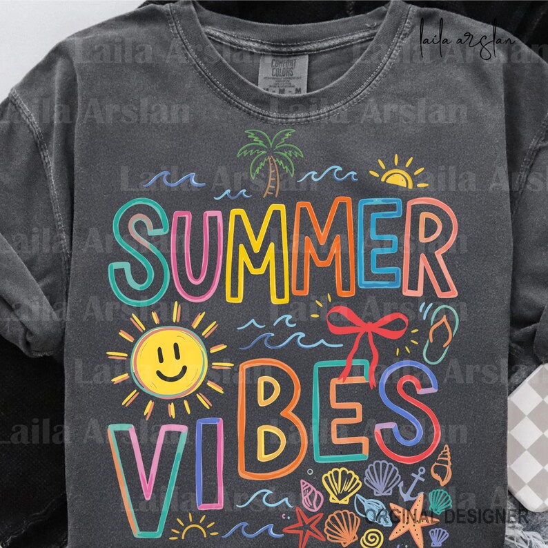 May include: Dark gray long-sleeve shirt with the words "SUMMER VIBES" in colorful, outlined letters. The design includes a smiling sun, palm tree, waves, seashells, and a bow.