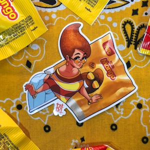 May include: A sticker featuring a cartoon woman with orange hair and sunglasses, wearing a striped shirt and holding a bag of mango-flavored candy. The bag has the text "Vero Mango" on it.
