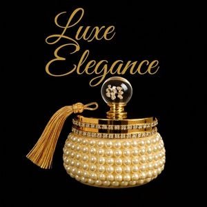 May include: A round, cream-colored container covered in small, spherical faux pearls. The lid features a gold band encrusted with clear crystals, a gold tassel, and a clear glass sphere topper containing a small, gold-colored floral emblem. Text reads Luxe Elegance.
