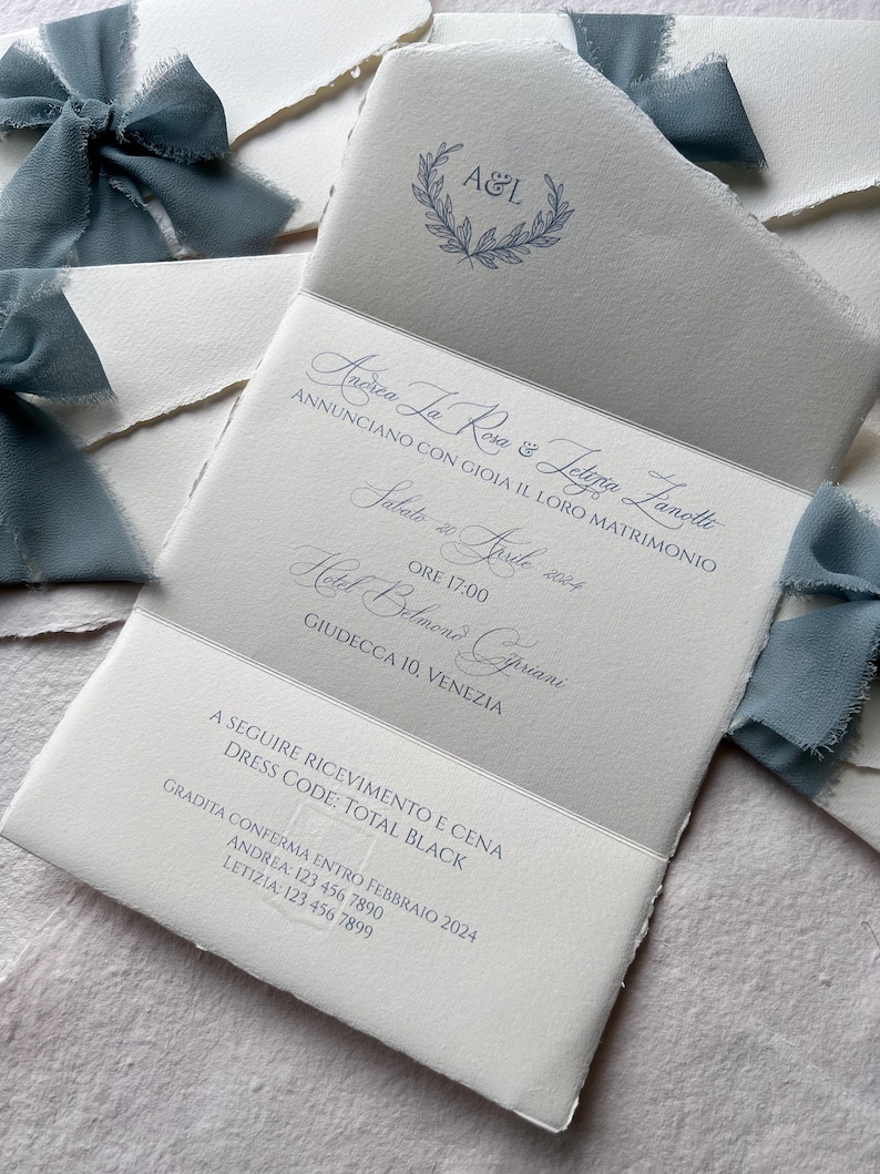 May include: A wedding invitation with a white background and blue text. The invitation announces the marriage of Andrea La Rosa and Lettizia Lanolle on Saturday, April 20, 2024 at 5:00 PM at the Hotel Belmond Cipriani in Venice, Italy. The invitation also includes the dress code: Total Black.