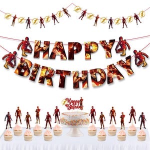 May include: A birthday party set featuring a cake, cupcakes, and decorations with a superhero theme. The cake is topped with a "Happy Birthday" cake topper. The banner spells out "Happy Birthday" with superhero imagery.