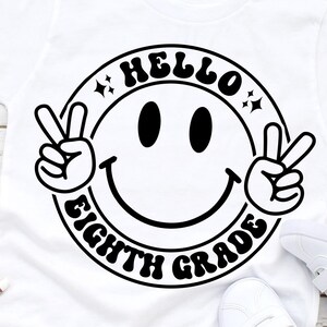 May include: White t-shirt with a black smiley face design that says "Hello Eighth Grade" in a retro font.