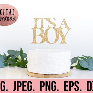May include: Gold glitter cake topper with the text "It's a Boy" on a white cake.