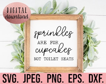 May include: A wooden framed sign with the text "sprinkles are for cupcakes not toilet seats" in black script. The sign is surrounded by green foliage and includes the words "DIGITAL download" in a pink circle.