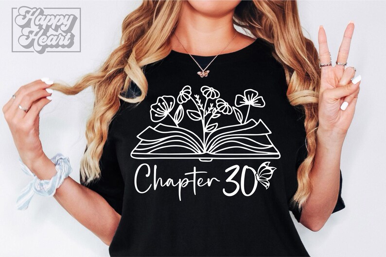 May include: Black t-shirt with a white outline of an open book with flowers growing from it. The text "Chapter 30" is below the book with a butterfly to the right of the number.