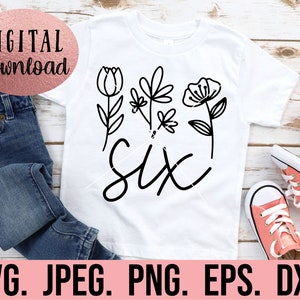 May include: A white t-shirt with a black design of the word "six" surrounded by stylized flowers. The design is perfect for a child's birthday.