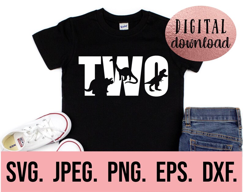 May include: Black t-shirt with white text that says "TWO" with dinosaur silhouettes inside the letters. The shirt is on a white background with a pair of white trainers and blue jeans.