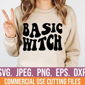May include: A beige sweatshirt with the text "BASIC WITCH" in black, retro-style lettering. The text is centred on the sweatshirt. The sweatshirt is being worn by a person with long brown hair. The image is a product photo for a digital download of a cut file.