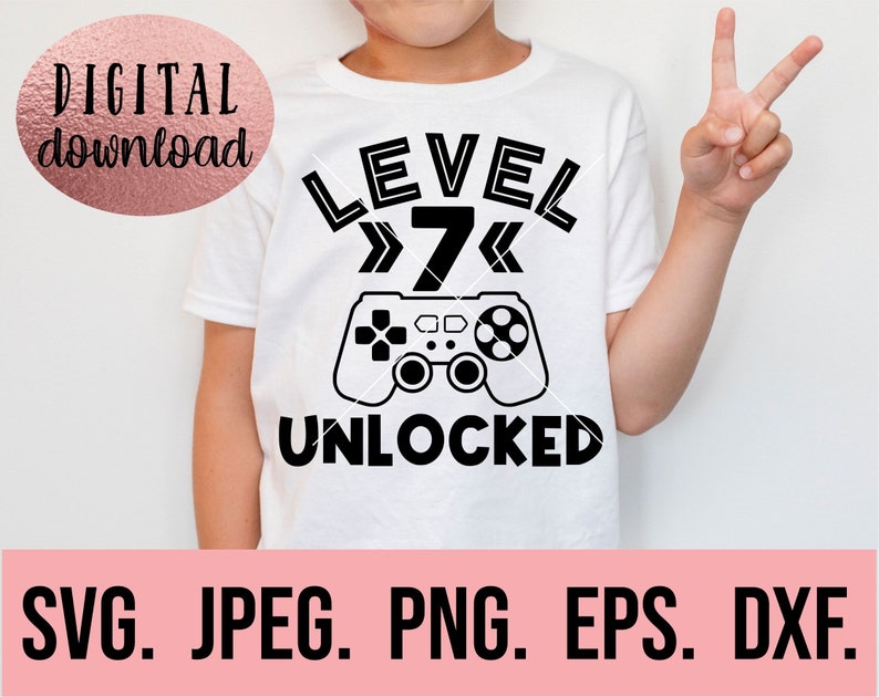 May include: A white t-shirt with black text that reads "LEVEL 7 UNLOCKED". A black and white illustration of a video game controller is above the text.