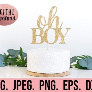 May include: Gold glitter cake topper with the text "Oh Boy" on a white cake. The cake is on a wooden base. The image is on a white background.