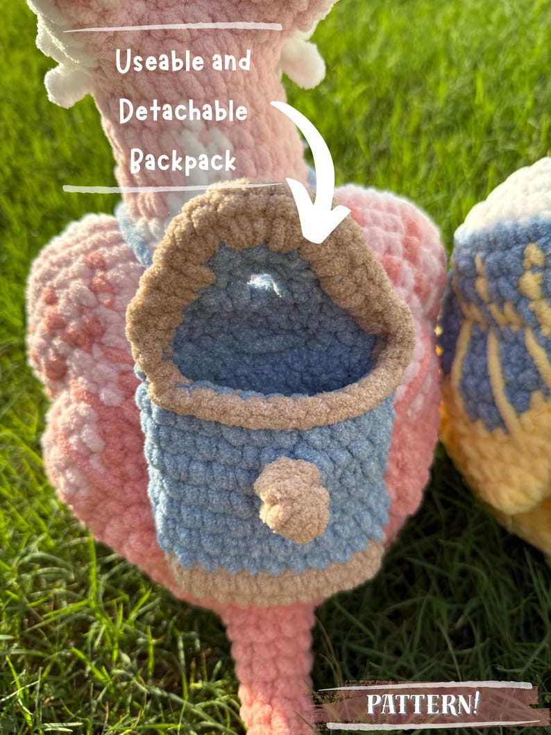 May include: Close-up of a handmade crochet item with a detachable backpack. The item is primarily pink, with a blue and tan backpack. The text "Useable and Detachable Backpack" and "PATTERN!" are visible.