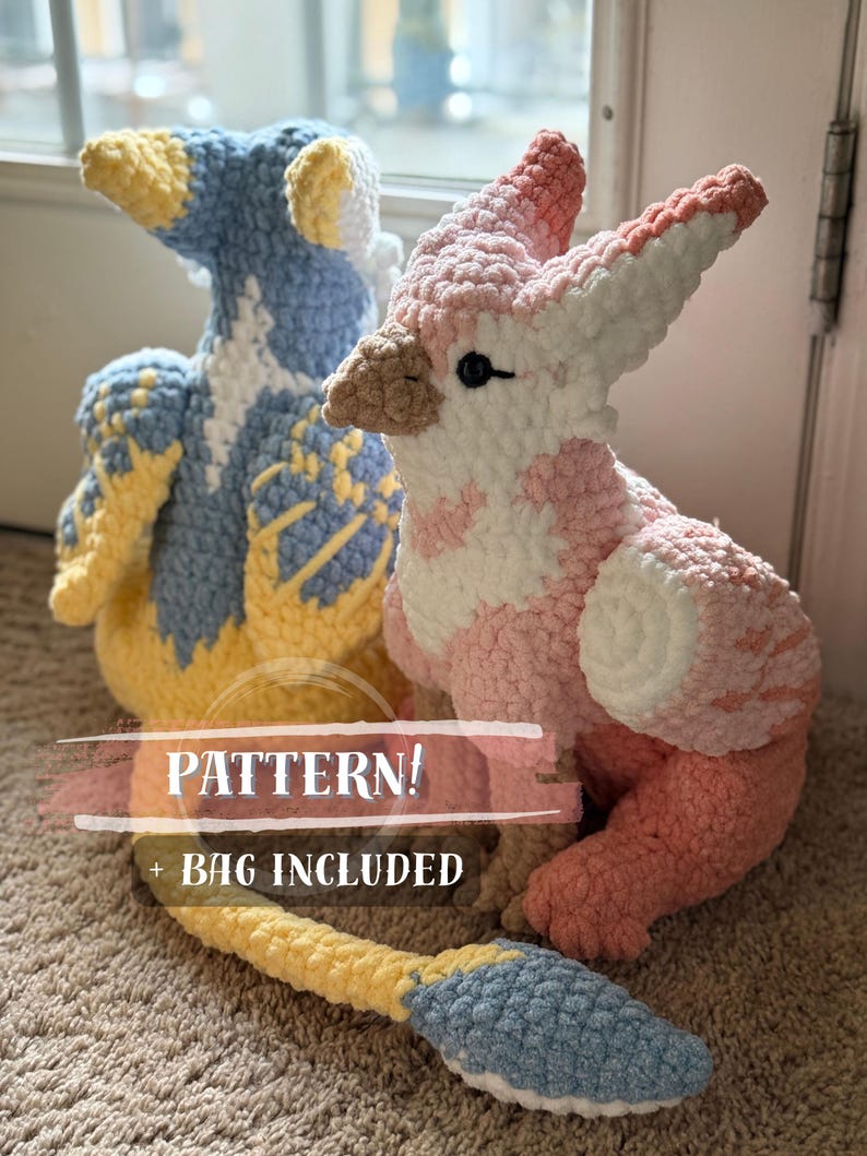 May include: Two handmade crochet bird plushies. One is blue, yellow, and white, the other is pink and white. The text "PATTERN! + BAG INCLUDED" is overlaid on the image. The plushies are on a carpeted surface.