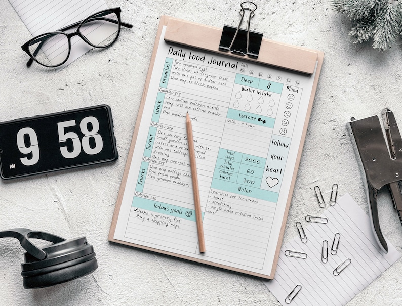 May include: A daily food journal with sections for breakfast, lunch, dinner, and snacks. The journal includes space to track sleep, water intake, mood, exercise, total steps, total minutes, calories burned, and notes. The journal also includes a section for today's goals and exercises for tomorrow.