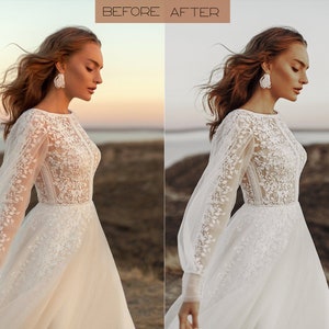 May include: A woman wearing a white lace wedding dress with long sleeves and a flowing skirt. She is standing in a field with a body of water in the background. The sun is setting in the distance, casting a warm glow on the scene.