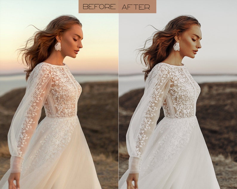 May include: A woman wearing a white lace wedding dress with long sleeves and a flowing skirt. She is standing in a field with a body of water in the background. The sun is setting in the distance, casting a warm glow on the scene.
