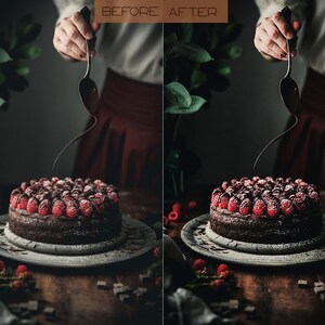 May include: A chocolate cake topped with raspberries and powdered sugar is being drizzled with chocolate sauce. The cake is on a wooden table with a plate and some chocolate pieces.