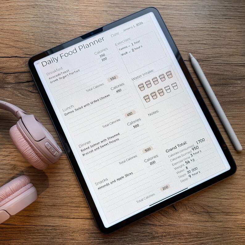 May include: A digital tablet displaying a daily food planner with sections for breakfast, lunch, dinner, and snacks. The planner includes a section for tracking calories, water intake, and exercise. The date is January 1, 2024.