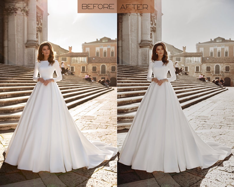 May include: A white wedding dress with long sleeves and a full skirt. The dress is photographed in front of a building with a stone facade.