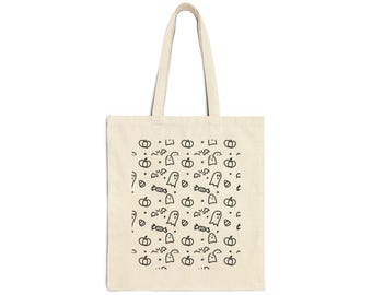 May include: A beige canvas tote bag featuring a repeating black line art pattern of ghosts, pumpkins, bats, and candy pieces. The bag has two long shoulder straps and a rectangular body, showcasing a simple, monochromatic Halloween-themed design.