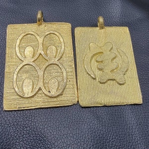Gye Nyame and Mati Masie Pendant, Ashanti Brass