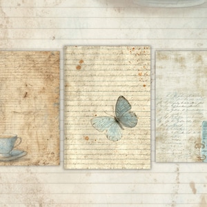 May include: Three vintage-style prints on aged paper. One features a blue teacup and saucer, another a light blue butterfly, and the third has script and a blue accent. The background has a wood grain pattern.