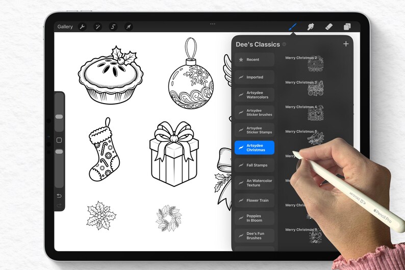 May include: A digital illustration on a tablet screen featuring black and white Christmas-themed drawings, including a pie, ornament, stocking, gift box, and floral designs. The tablet displays the "Dee's Classics" menu.